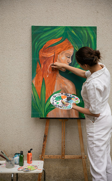 man cast i shadow paints on a canvas, with yellow and red flowery paintings on a tarp wall